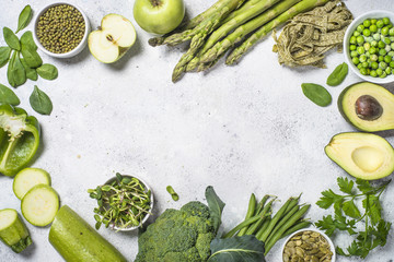 Green food assortment on light stone background. 