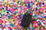 Car key on confetti background