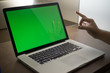© MuhammadSyafiq - A laptop with green screen and hand gesture