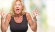 © Krakenimages.com - Middle age blonde woman over isolated background celebrating crazy and amazed for success with arms raised and open eyes screaming excited. Winner concept