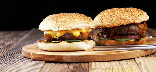 Tasty fresh meat burgers with salad and cheese. Homemade angus burger.