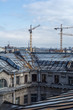 © merrymirta - Saint Petersburg, Russia - April 2018: View of the city from the roof of old houses in historical downtown at sunny day, construction cranes