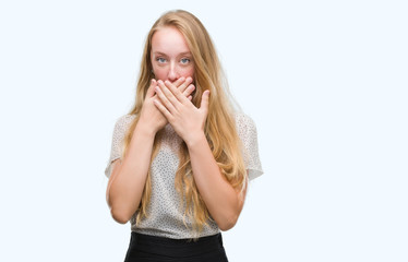 Canvas Print - Blonde teenager woman wearing moles shirt shocked covering mouth with hands for mistake. Secret concept.