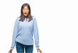 © Krakenimages.com - Young asian woman wearing winter sweater over isolated background afraid and shocked with surprise expression, fear and excited face.