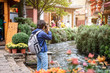© Kittiphan - Young traveler walking and photographing at lijiang old town in Yunnan province, China