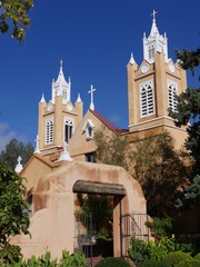 Wall Mural - Close up portrait shot of the San Felipe de Neri Parish, a historic catholic church on the Old Town Plaza of Albuquerque, New Mexico  