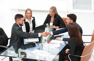 Sticker - handshake of business partners sitting at your Desk