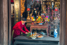 Old Vietnamese Man Preparing Altar With Foods For The Last Meal Of Year. The Penultimate New Years Eve - Tat Nien, The Meal Finishing The Entire Year. Vietnam Lunar New Year.
