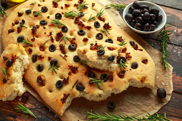 Wall Mural - Homemade Italian focaccia with sun dried tomatoes, black olives and rosemary