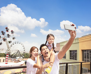 happy family taking selfie in the park