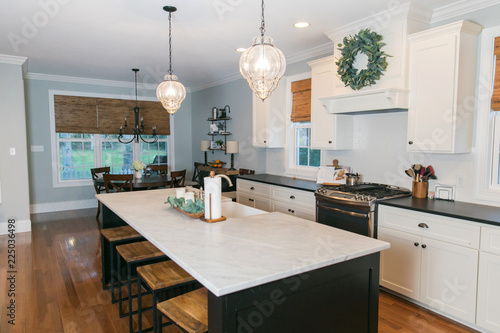 Spacious Modern Kitchen With Dark And White Cabinets Wood Floors