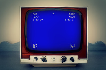 A retro vintage TV showing an old blank clean VHS tape playing. Blue screen with various information, text and symbols.
