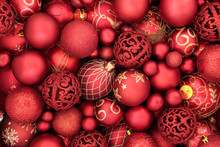 Red Bauble Christmas Decorations Forming An Abstract Background. Traditional Christmas Greeting Card For The Holiday Season. Top View.