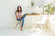 © satura_ - Technology and people concept - Young beautiful woman sitting at the white table with digital tablet