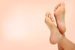 Female feet against pastel background. Skin care concept