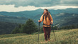 © Yakobchuk Olena - Full length of a nice sporty female traveler using Nordic walking sticks while having an active weekend in the mountains