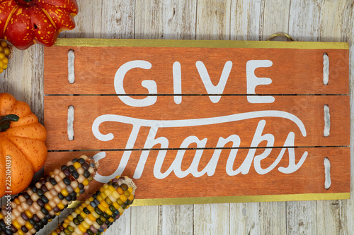 Fotografie, Obraz Give Thanks text phrase Thanksgiving holiday background with plaid pumpkins