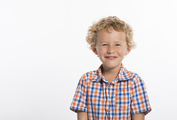 Giggling little boy in plaid shirt, isolated on white background