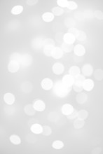 Elegant Abstract Silver Christmas Background With White Bokeh Lights For Holiday Poster, Banner, Ad, Card Or Invitation..