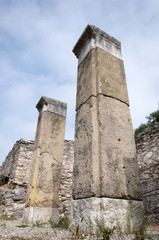 two columns and the ruins of an ancient city