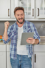 Enthusiastic man with digital tablet