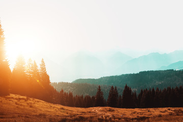 sun rising over a misty mountain landscape