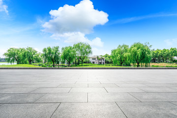 Empty square floor and green forest natural scenery in the city park