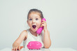 © Myst - beautiful cute little girl talking on toy telephone with very excited expression