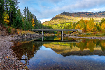 Wall Mural - bridge over a creek surrounded by autumn colors, Glacier National Park, Montana