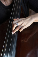 Hands Of A Musician Playing On A Contrabass Closeup