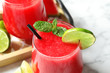 Summer watermelon drink with mint and lime on table, closeup