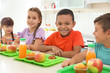 © New Africa - Children sitting at table and eating healthy food during break at school