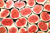 Fototapeta Kuchnia - Cut ripe figs as background, top view