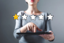 One Star Rating With Business Woman Using A Tablet Computer