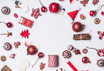 Christmas ornaments round circle frame composition on white background, top view. Red Christmas decoration and gift wrapping and package objects flat lay