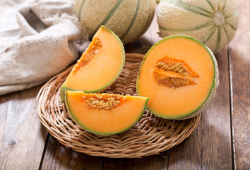 Wall Mural - cantaloupe melon on wooden table