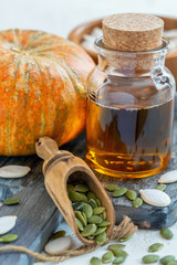 Wall Mural - Pumpkin seed oil cold pressed in bottle close-up.