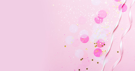 Wall Mural - Pink confetti and stars and sparkles on pink background.