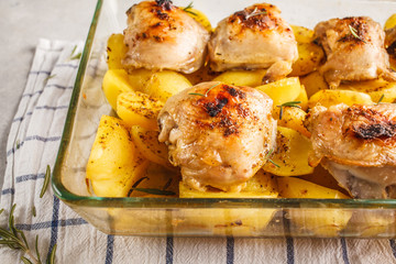 Wall Mural - Homemade baked potatoes with chicken in a glass dish. Simple home cooking concept.