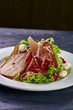 © alexmishchenko - Expensive Italian, Spanish, French salad for festive table. Snack from pear, mozzarella, jamon, greens, lettuce, sauce. Cuisine of France, Spain, Italy. Photo of food for menu, cookbook, culinary blog