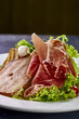 © alexmishchenko - Expensive Italian, Spanish, French salad for festive table. Snack from pear, mozzarella, jamon, greens, lettuce, sauce. Cuisine of France, Spain, Italy. Photo of food for menu, cookbook, culinary blog
