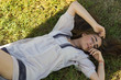 © yursavieno - Beautiful young woman in white dress lying on grass