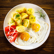 Fried Eggs, Boiled Potatoes And Vegetables