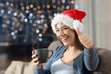 Happy Woman With Thumbs Up On Christmas At Home