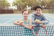 © SewcreamStudio - Happy and healthy young mixed Asian children tennis player on outdoor blue court