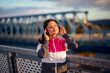 © Novak - Fit woman take a break after jogging,listening music with headphones
