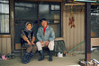 © hideo tsuto - Portrait of senior couple sitting at porch