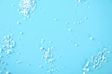 Wall Mural - Crystals of large sea salt on a blue table.