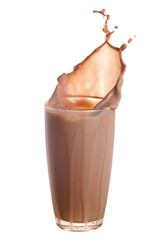 Wall Mural - Chocolate milk splash out of glass isolated on white background.