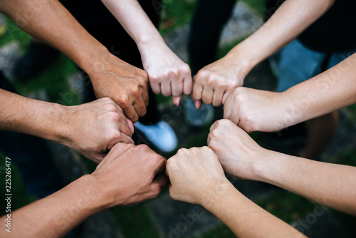 Cuadros en Lienzo Close up of students standing hands making fist bump gesture.